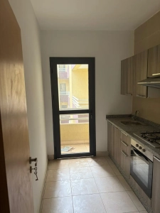 Cuisine de l'appartement 4 pièces à louer à Attécoubé, Cité ADDOHA avec porte ouvrant sur le balcon